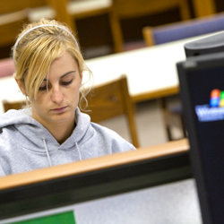 Image of a student at a library computer.